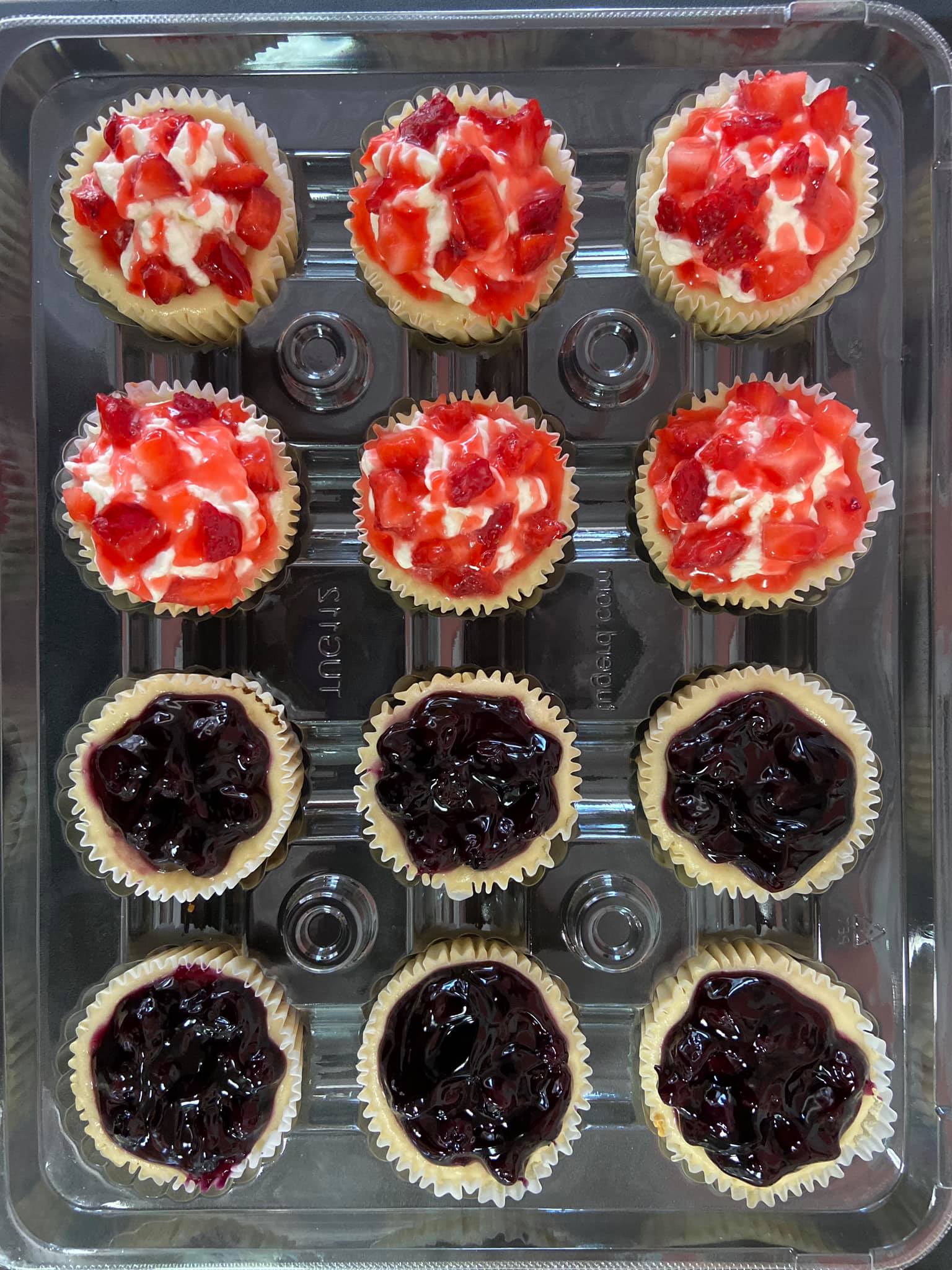 Top view image of strawberry and berry cheesecakes in package